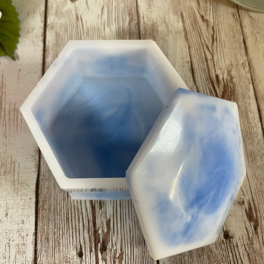 Hexagonal silicone mold with blue and white gradient on a wooden surface