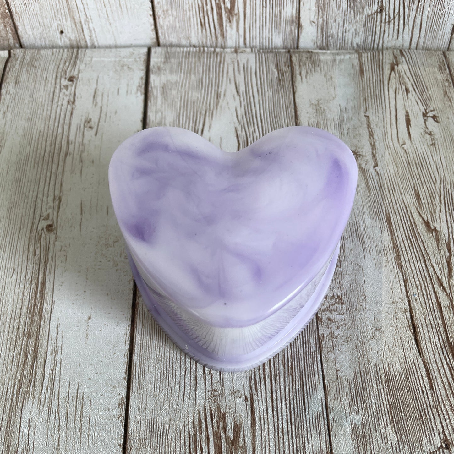 Purple marble heart jewelry boxon a wooden surface