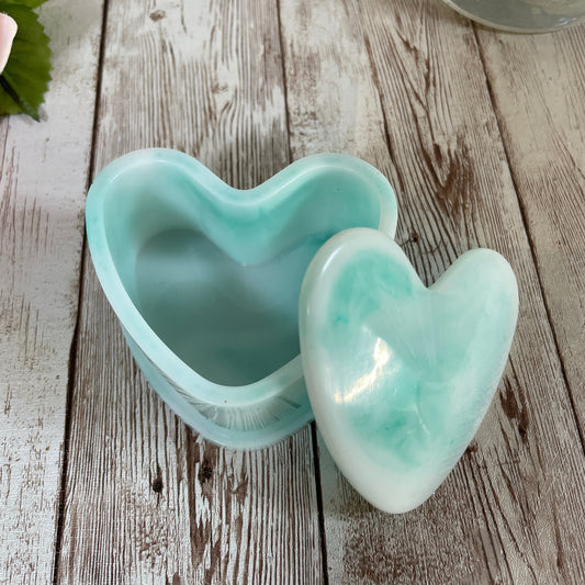 Heart-shaped jewelry box on a wooden surface