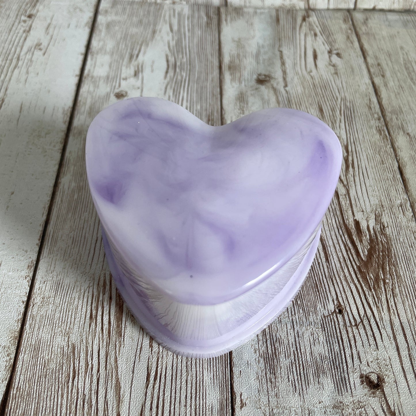 Purple marble heart jewelry box on a wooden surface