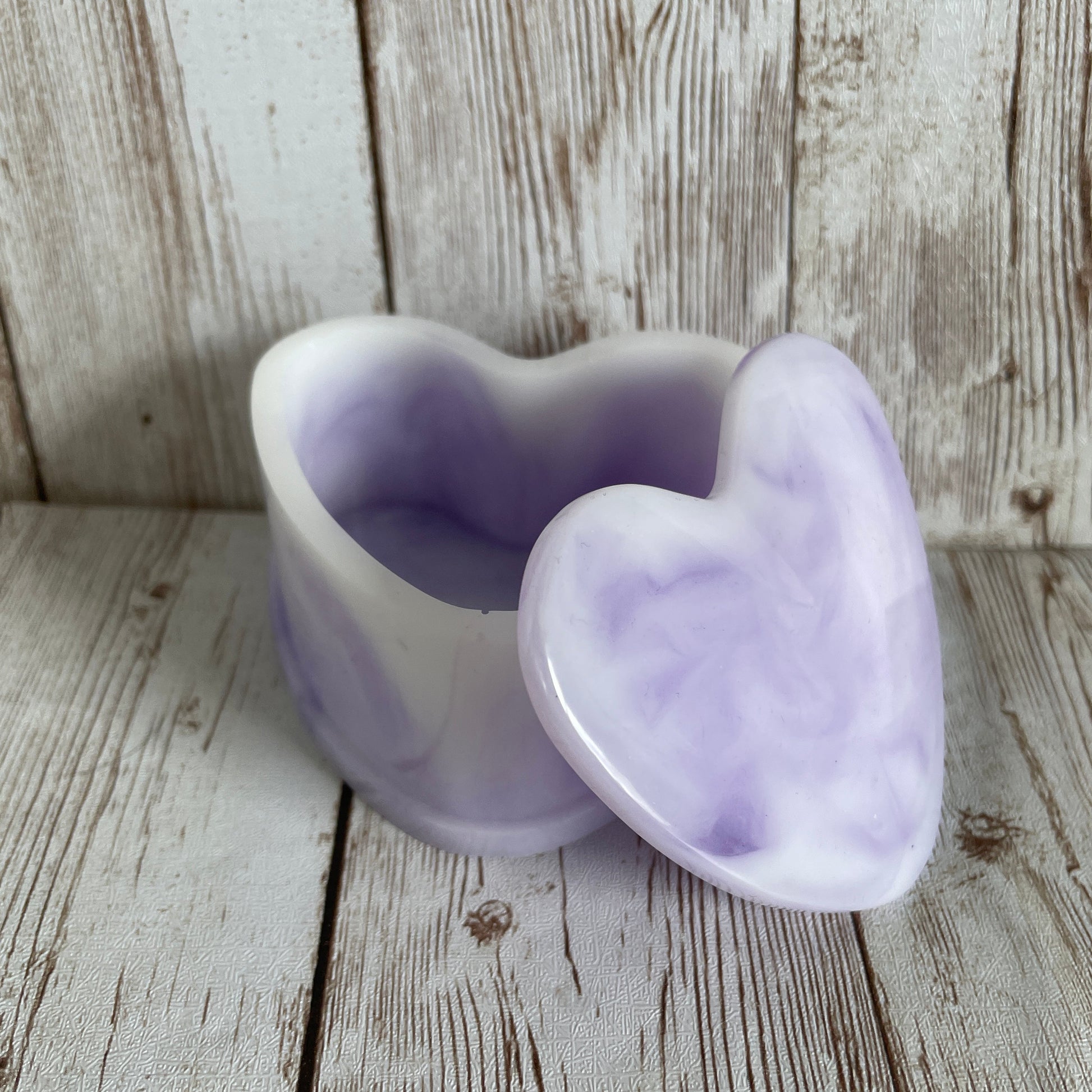 purple marble heart jewelry box on a wooden surface