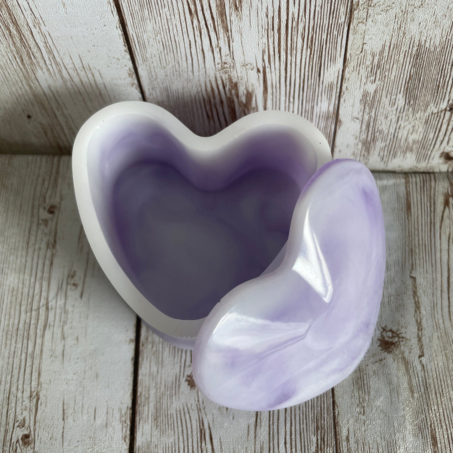 Purple marble heart jewelry box on a wooden surface