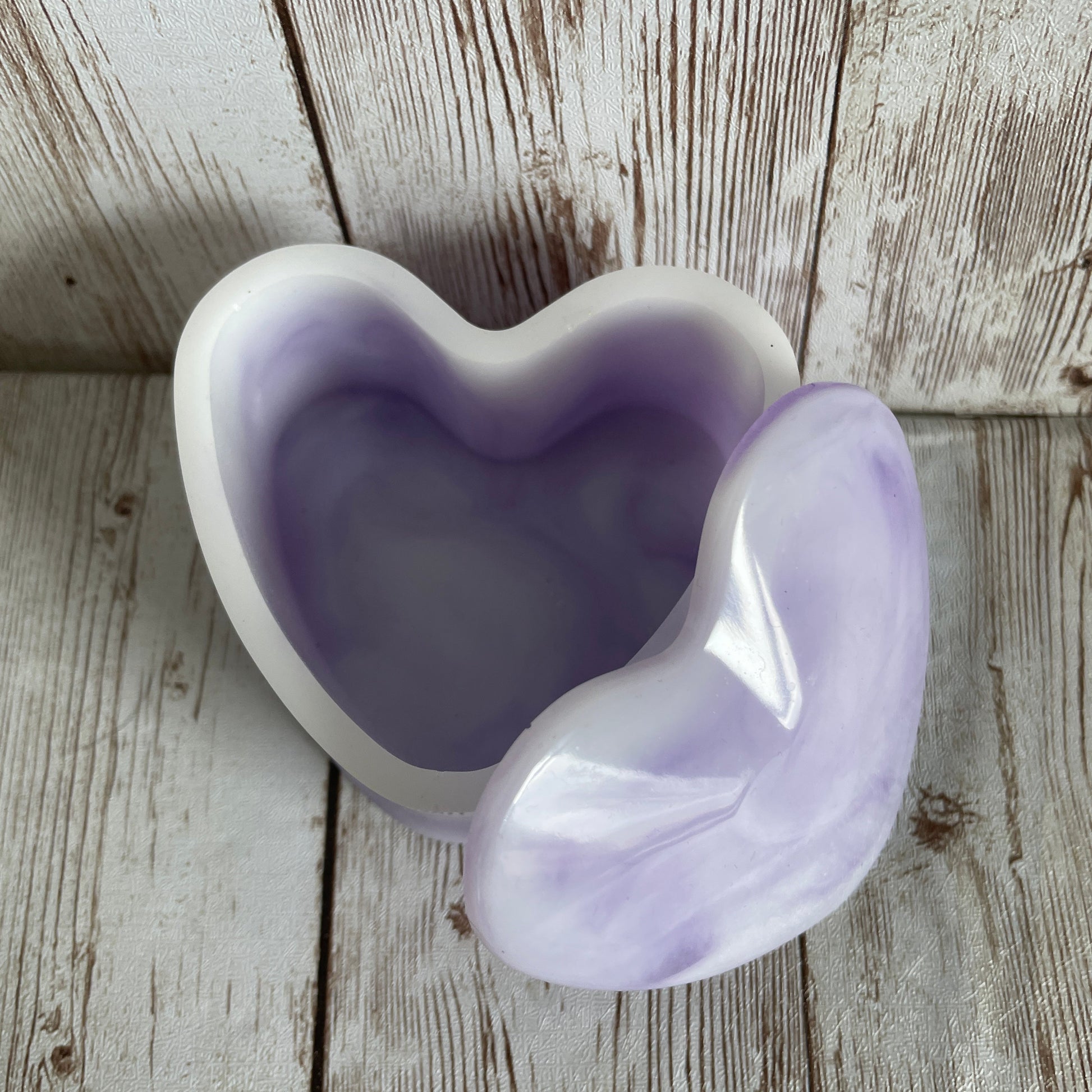 Purple marble heart jewelry box on a wooden surface